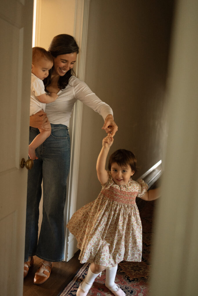 dancing in the hallway with mom during an in-home family sesssion